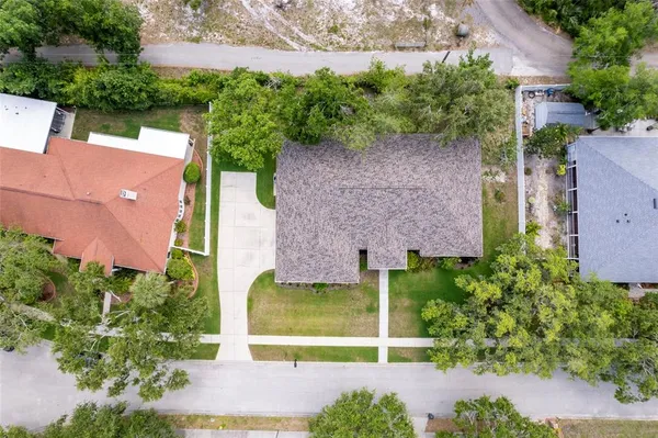 an aerial view of residential house with outdoor space and trees