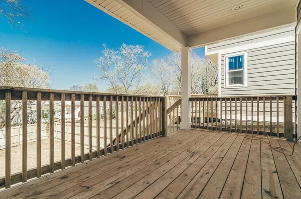 a view of wooden balcony with a barbeque