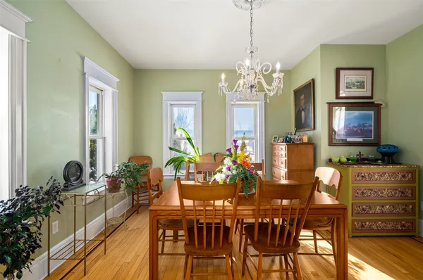 a view of a dining room with furniture and a chandelier