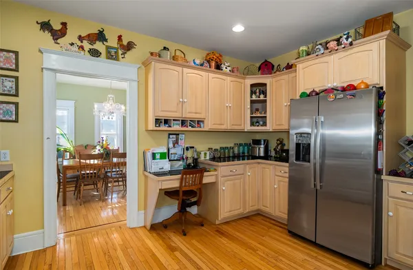 a kitchen with stainless steel appliances granite countertop a refrigerator and a stove top oven