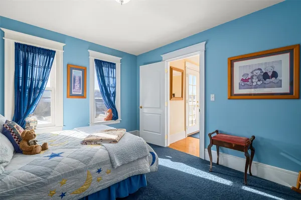 a bedroom with a bed and a painting on the wall