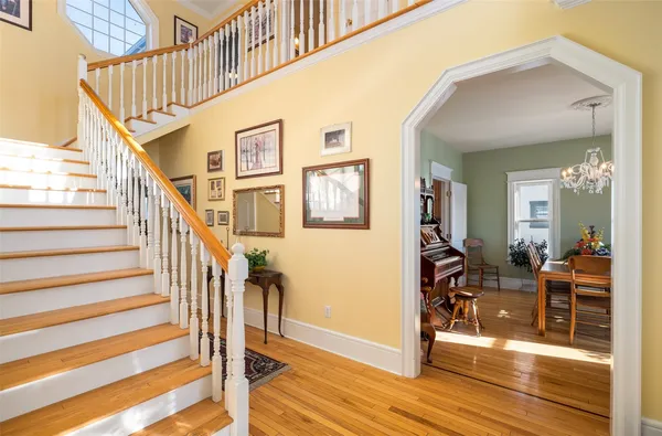 a view of a livingroom with wooden floor and furniture