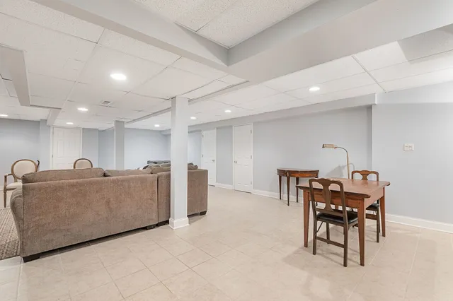 a living room with furniture and a dining table