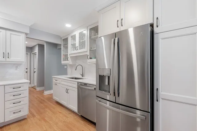 a kitchen with stainless steel appliances a refrigerator sink and cabinets