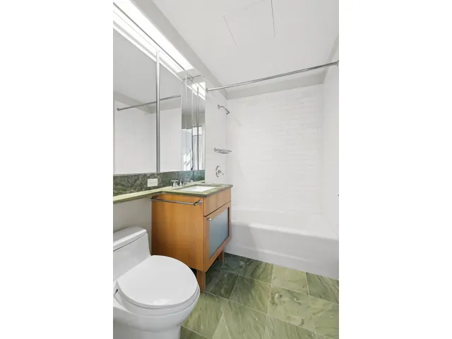 a bedroom with two beds and a large window