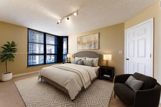 a spacious bedroom with a bed and a couch