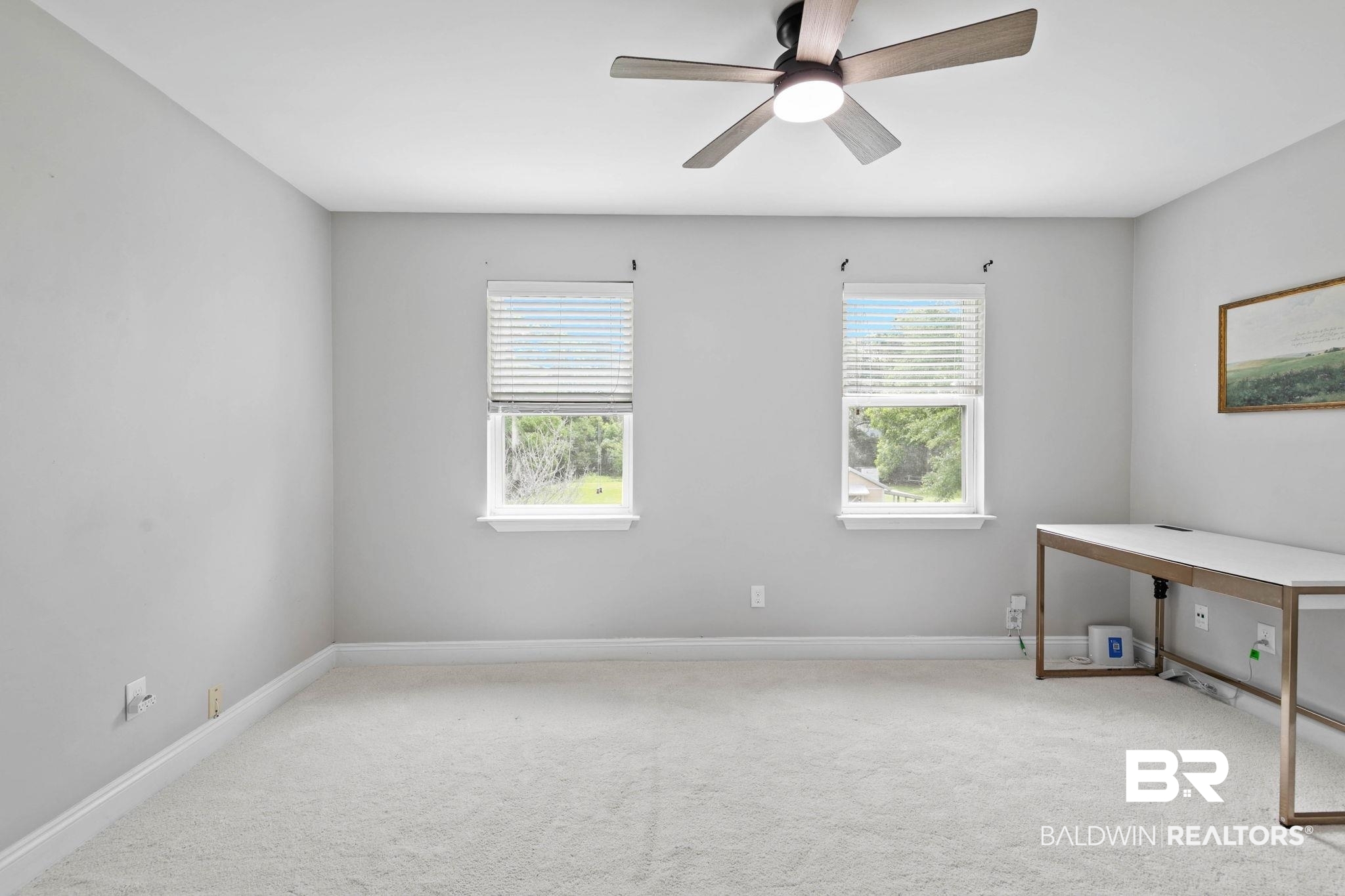22810 High Ridge Road Fairhope, AL 36532 - Photo 47 of 78 Carpeted room featuring two windows with blinds, a ceiling fan with integrated lighting, and neutral wall tones