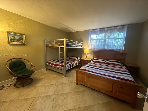 a bedroom with bed and a window
