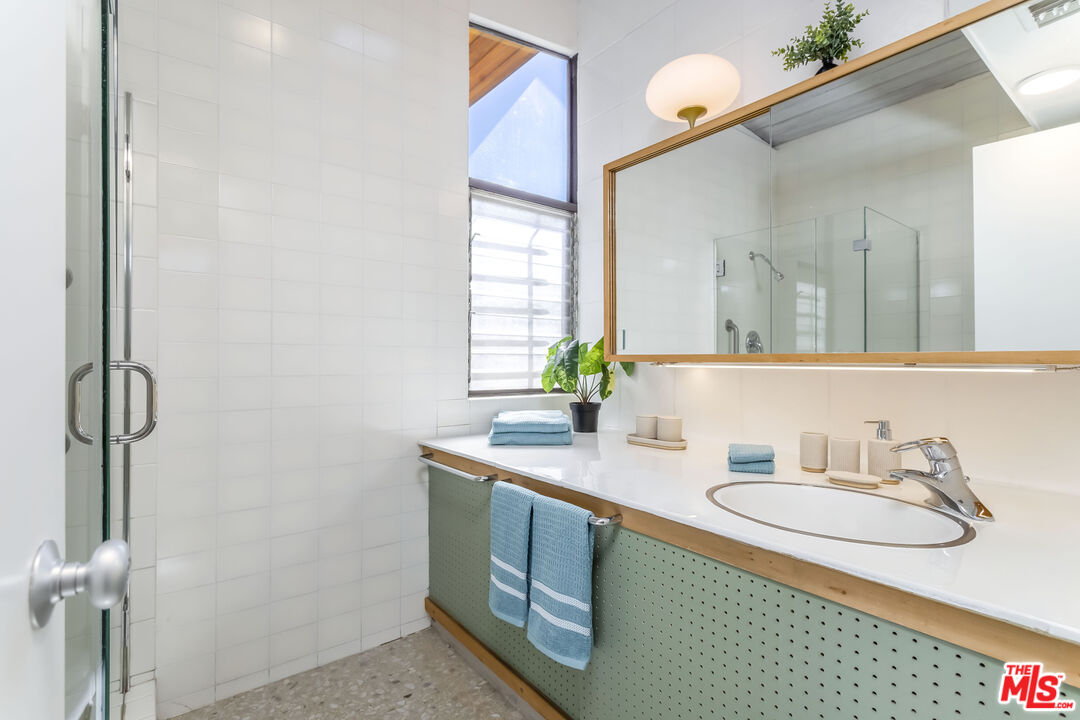 8554 Day Street Sunland, CA 91040 - Photo 18 of 34 a bathroom with a granite countertop sink and a mirror