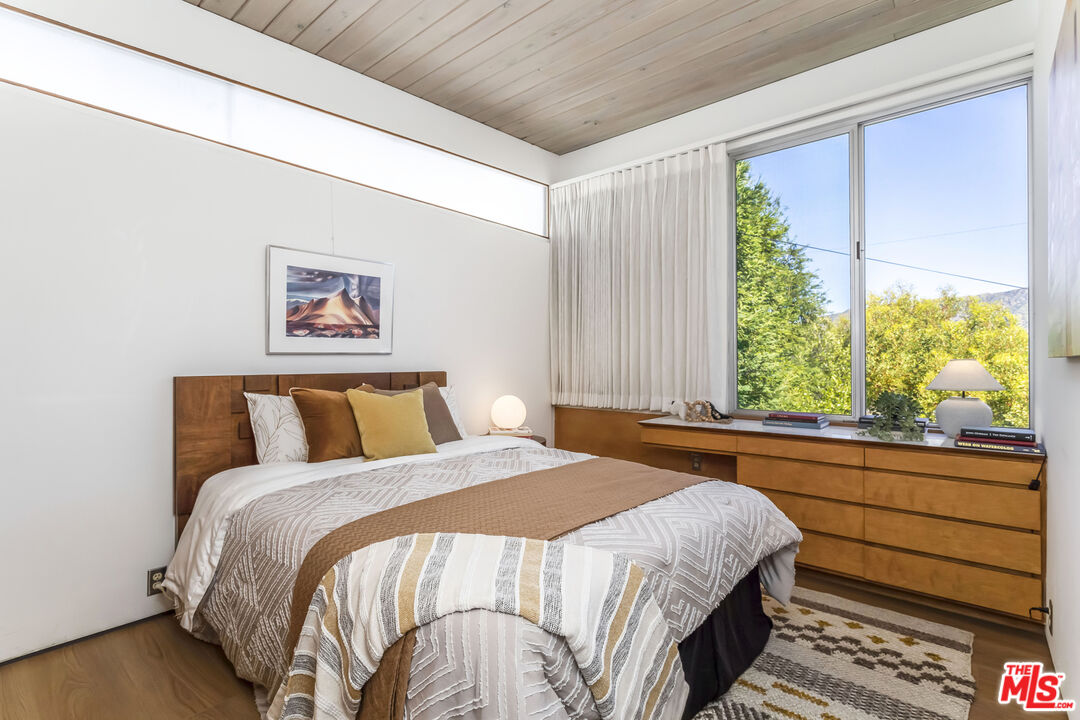 8554 Day Street Sunland, CA 91040 - Photo 22 of 34 a bedroom with a bed and a large window