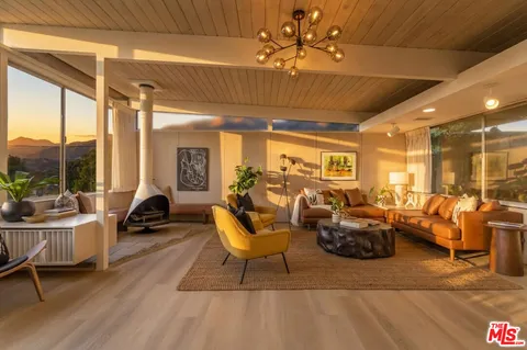 a living room with a table and a potted plant