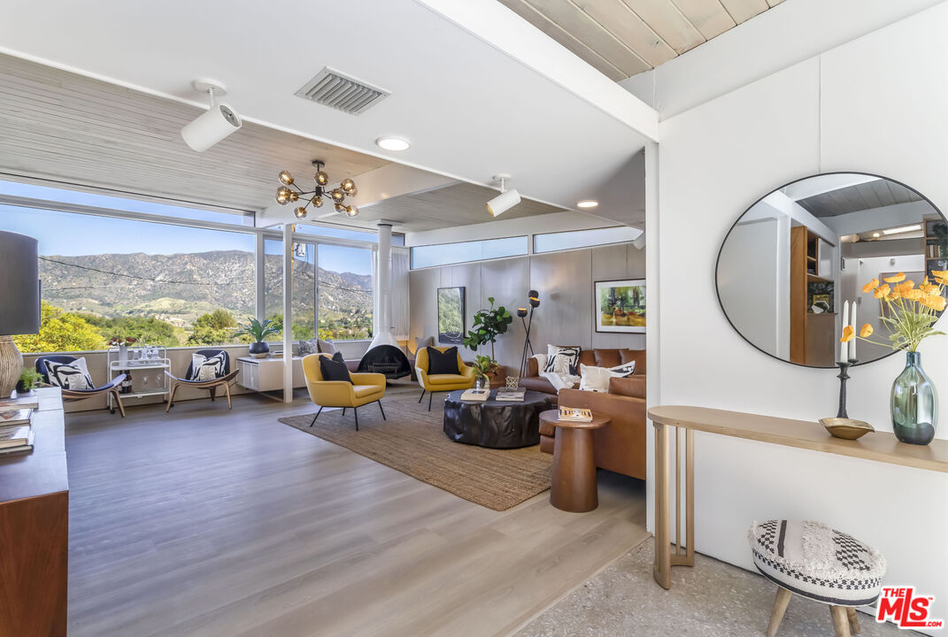 8554 Day Street Sunland, CA 91040 - Photo 10 of 34 a living room with furniture a window and a chandelier