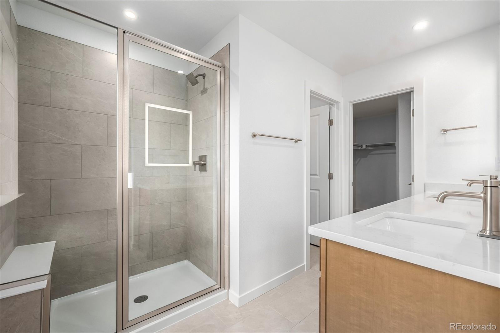 2076 South Holly Street, Unit 2 Denver, CO 80222 - Photo 11 of 24 a bathroom with a shower and a sink