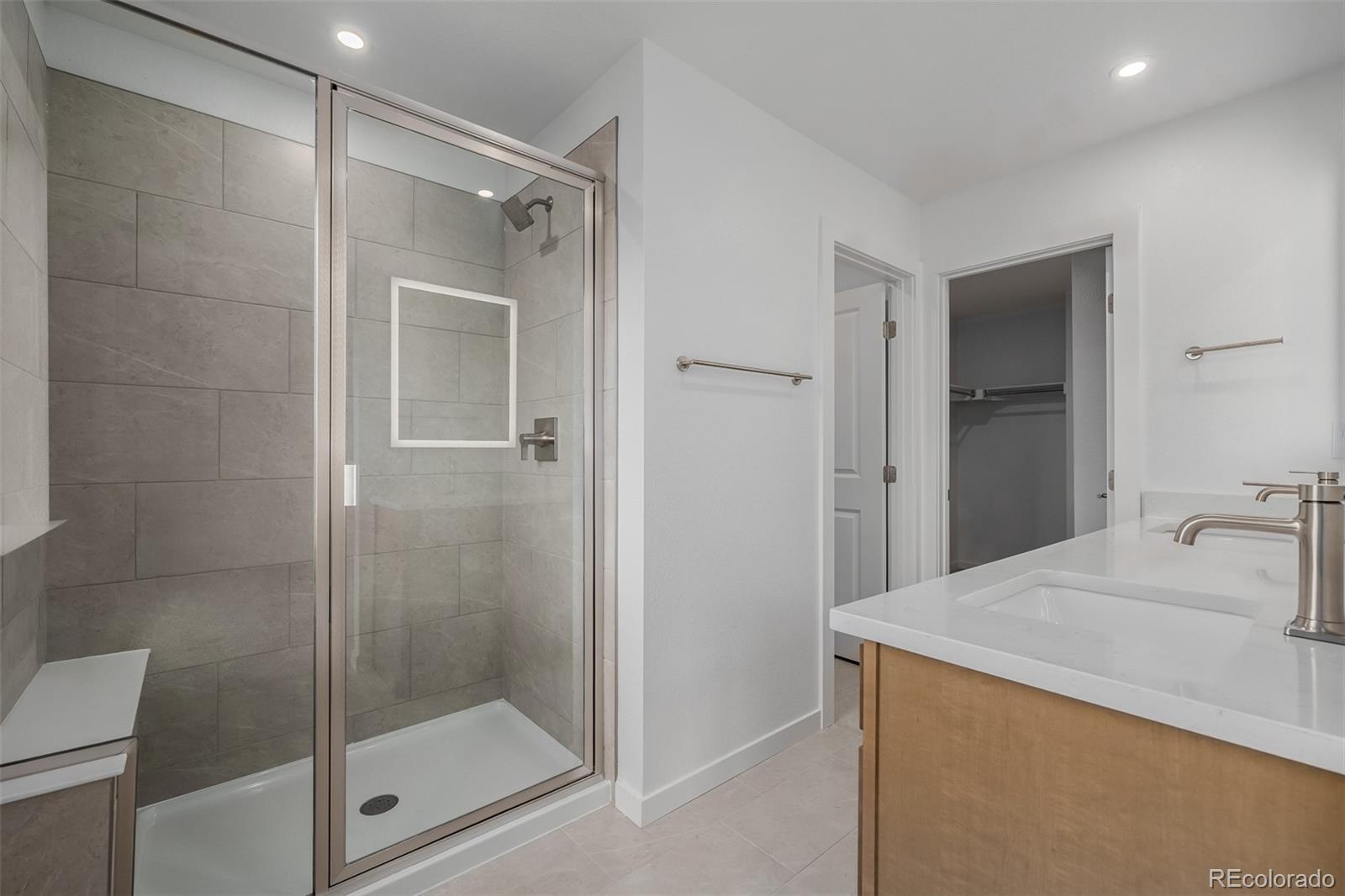 2076 South Holly Street, Unit 2 Denver, CO 80222 - Photo 13 of 22 a bathroom with a shower and a sink