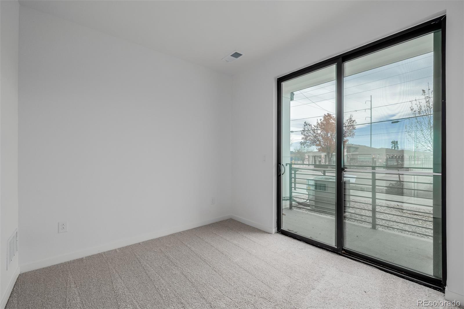 2076 South Holly Street, Unit 2 Denver, CO 80222 - Photo 15 of 22 a view of empty room with sliding door