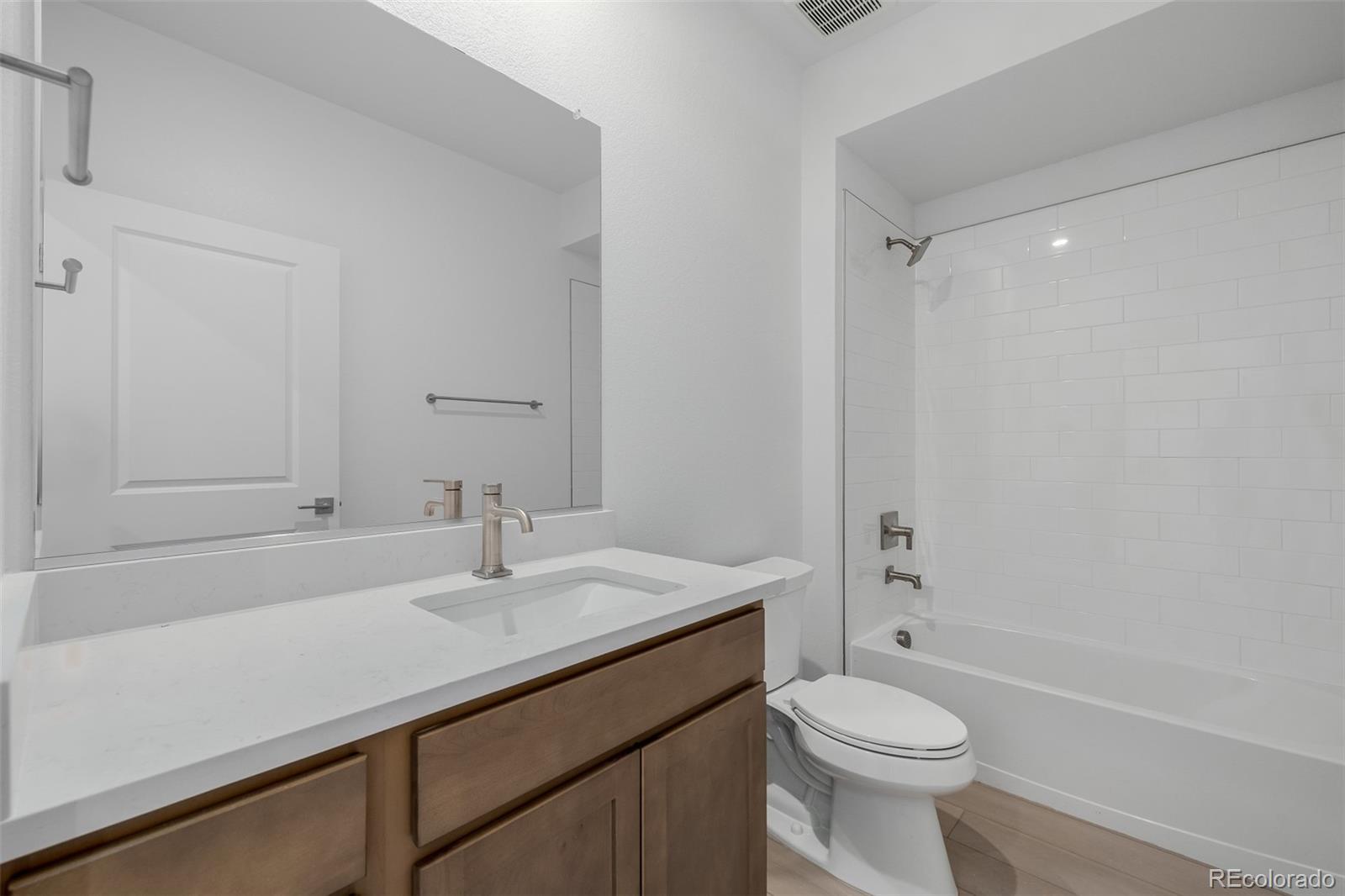 2076 South Holly Street, Unit 2 Denver, CO 80222 - Photo 16 of 22 a bathroom with a sink a toilet and shower