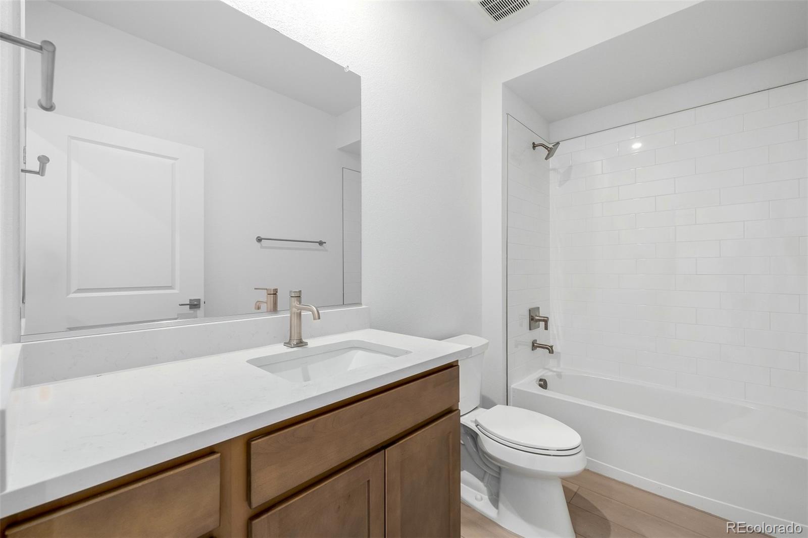 2076 South Holly Street, Unit 2 Denver, CO 80222 - Photo 16 of 24 a bathroom with a sink a toilet and shower