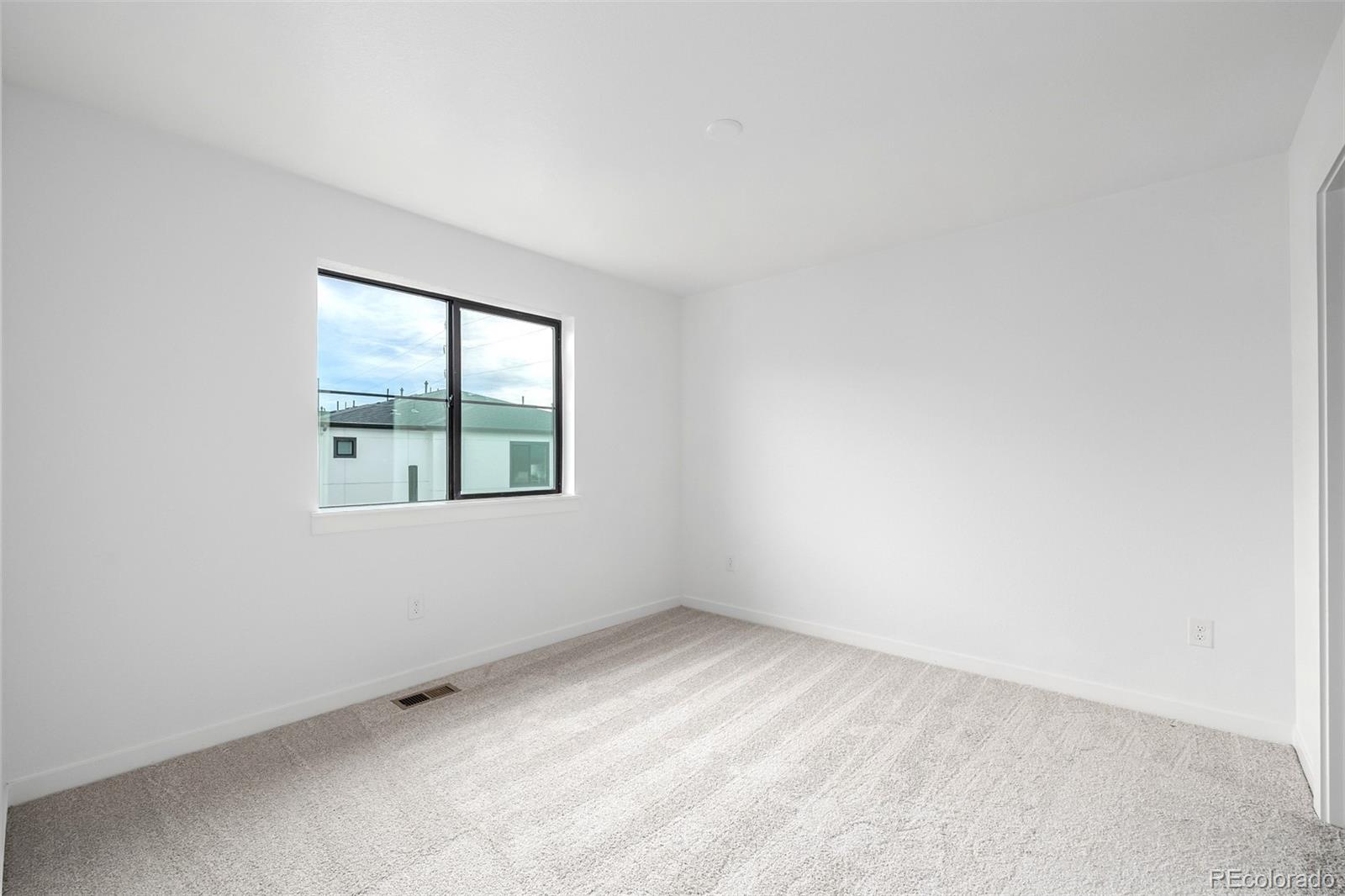 2076 South Holly Street, Unit 2 Denver, CO 80222 - Photo 17 of 24 an empty room with windows