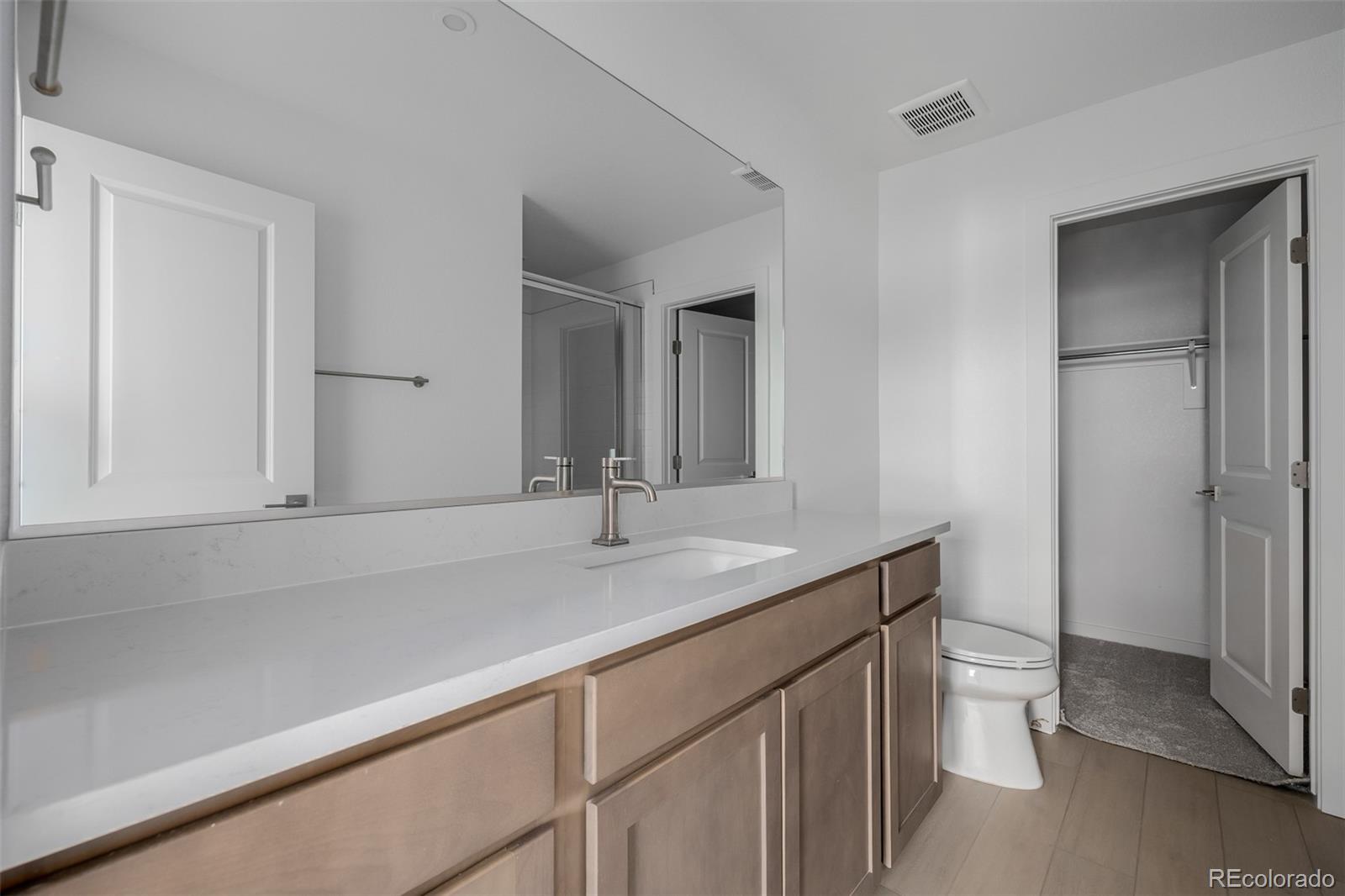 2076 South Holly Street, Unit 2 Denver, CO 80222 - Photo 19 of 22 a bathroom with a sink toilet and shower