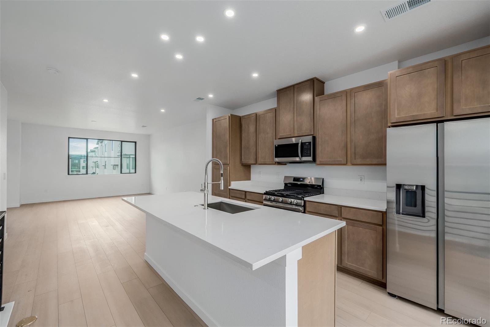 2076 South Holly Street, Unit 2 Denver, CO 80222 - Photo 2 of 22 a kitchen that has a lot of cabinets a sink and appliances in it