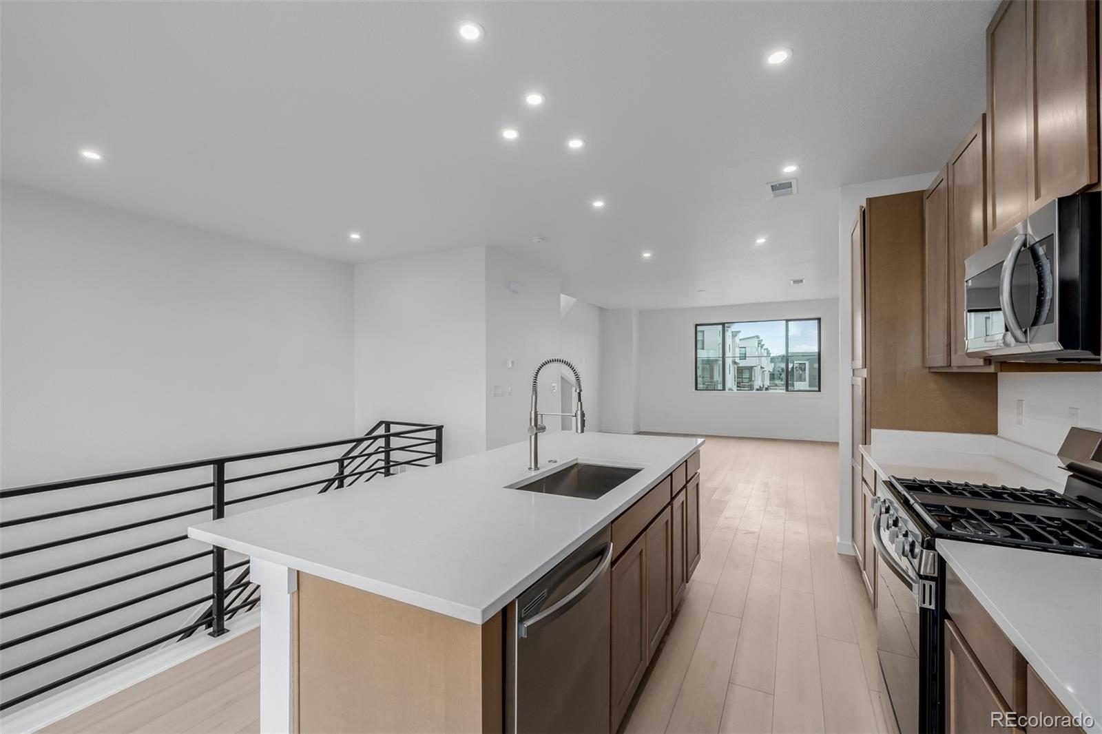 2076 South Holly Street, Unit 2 Denver, CO 80222 - Photo 3 of 22 a kitchen that has a sink and a stove in it