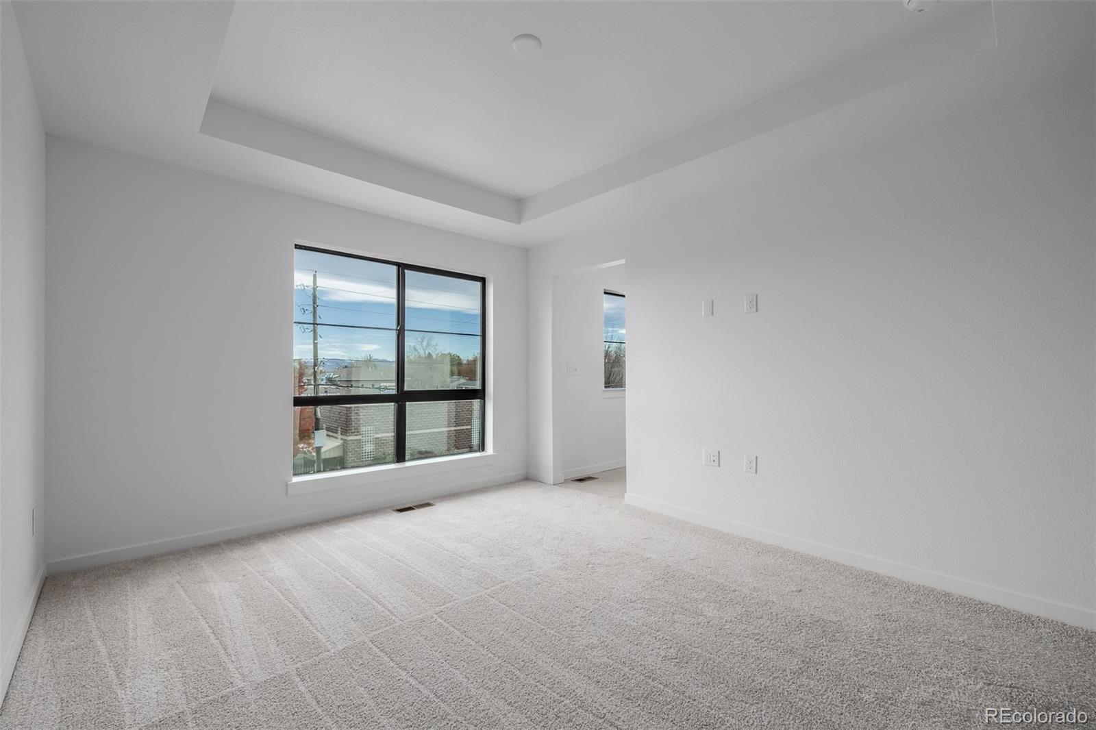 2076 South Holly Street, Unit 2 Denver, CO 80222 - Photo 10 of 24 a view of an empty room with a window