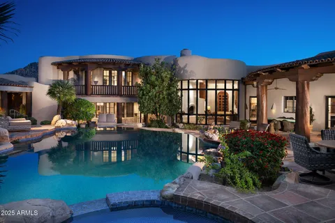 a front view of a house with garden and sitting area