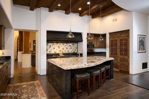 a kitchen with stainless steel appliances granite countertop a sink and a refrigerator