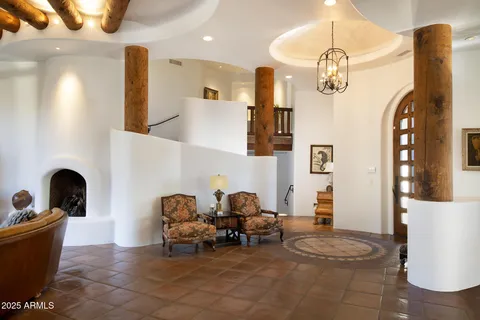 a bedroom with a bed and a lamp on dresser