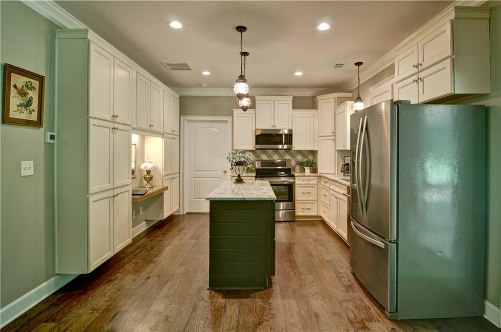 5800 Villa Rica Highway Dallas, GA 30157 - Photo 15 of 37 a kitchen with kitchen island a counter top space a refrigerator a sink and a stove