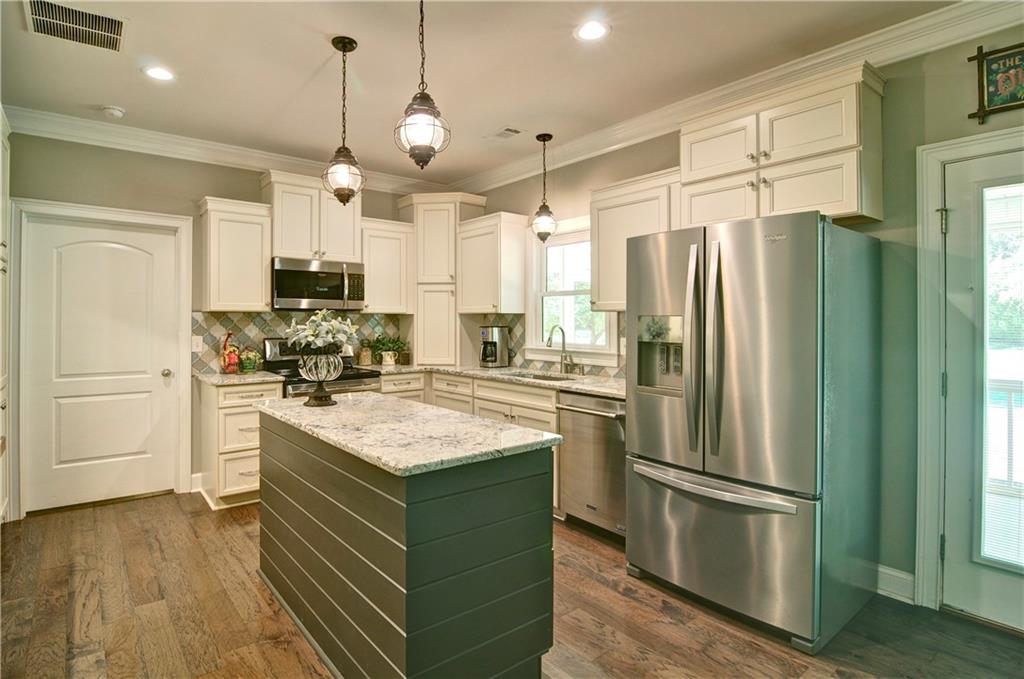 5800 Villa Rica Highway Dallas, GA 30157 - Photo 16 of 37 a kitchen with kitchen island white cabinets and stainless steel appliances