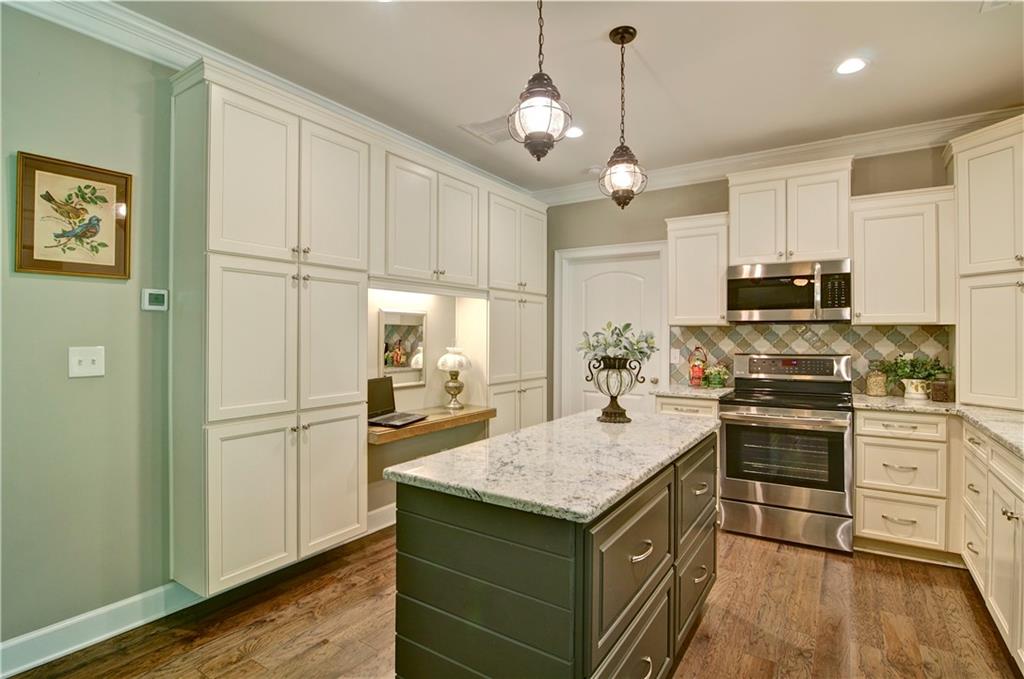 5800 Villa Rica Highway Dallas, GA 30157 - Photo 17 of 37 a kitchen with kitchen island granite countertop appliances cabinets and a wooden floor