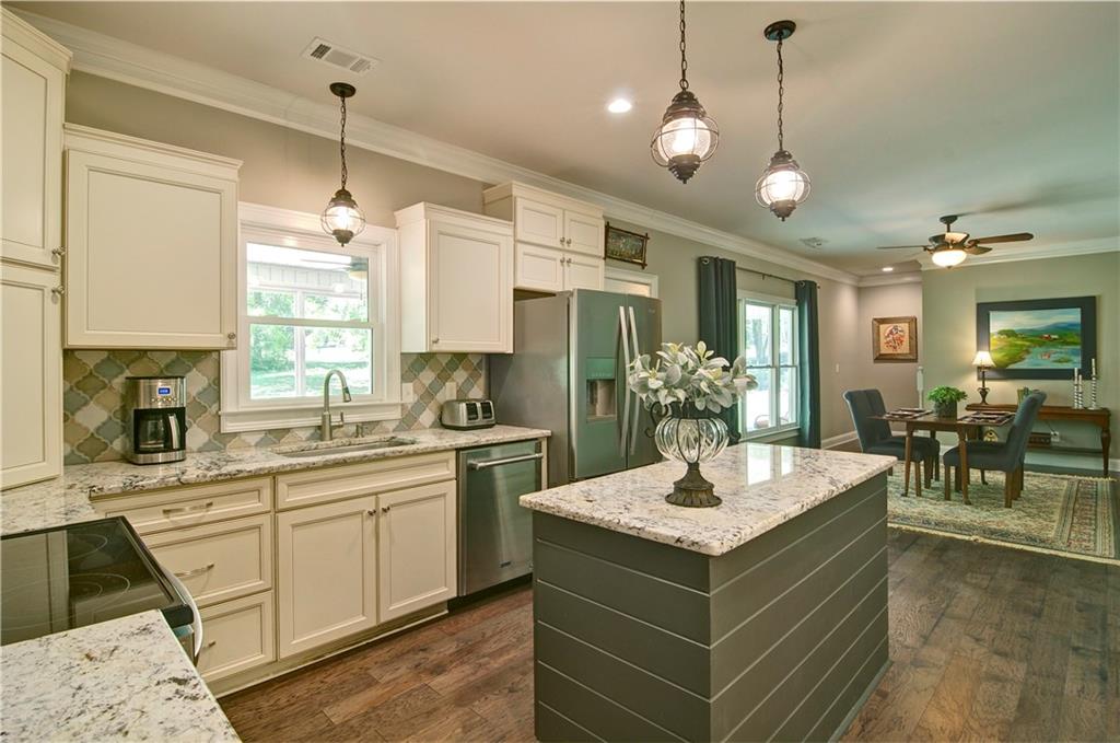 5800 Villa Rica Highway Dallas, GA 30157 - Photo 18 of 37 a kitchen with a stove sink and living room view