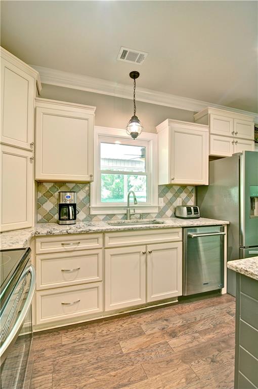 5800 Villa Rica Highway Dallas, GA 30157 - Photo 19 of 37 a kitchen with granite countertop a sink stainless steel appliances and cabinets