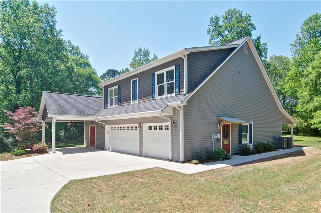 5800 Villa Rica Highway Dallas, GA 30157 - Photo 2 of 37 a front view of a house with a yard and garage