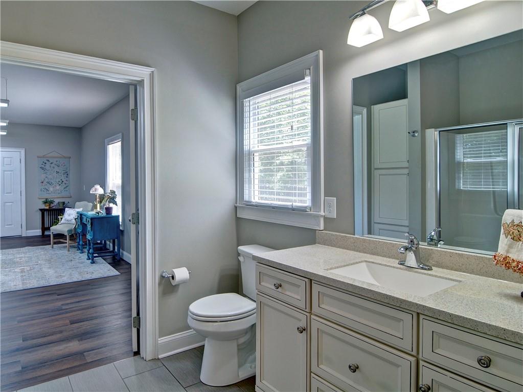 5800 Villa Rica Highway Dallas, GA 30157 - Photo 24 of 37 a bathroom with a toilet a sink and mirror