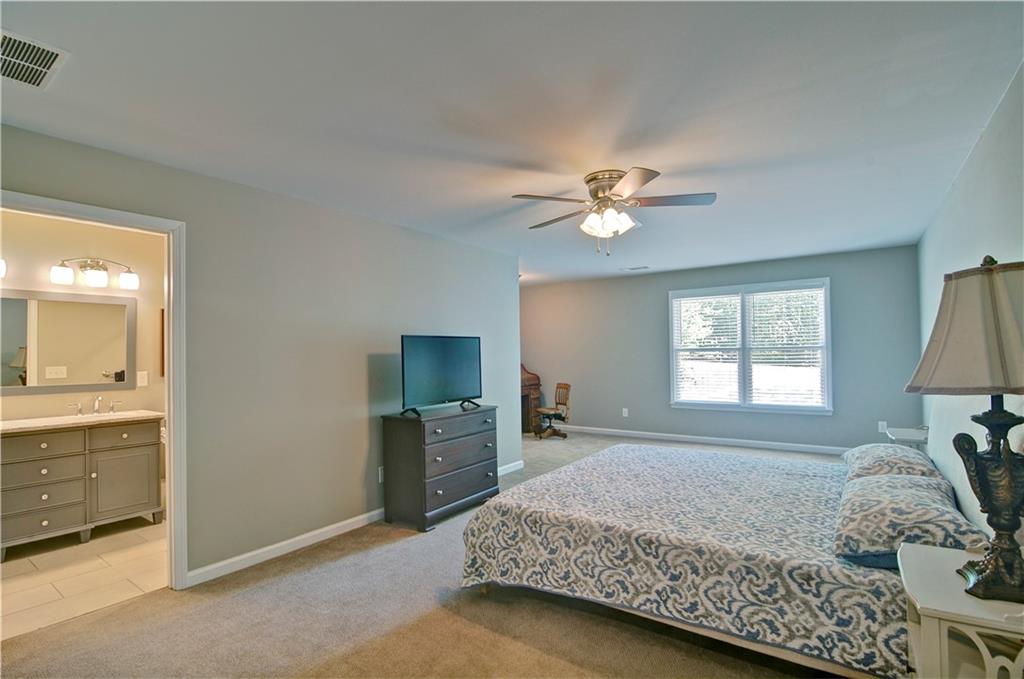 5800 Villa Rica Highway Dallas, GA 30157 - Photo 29 of 37 a spacious bedroom with a bed and a chandelier