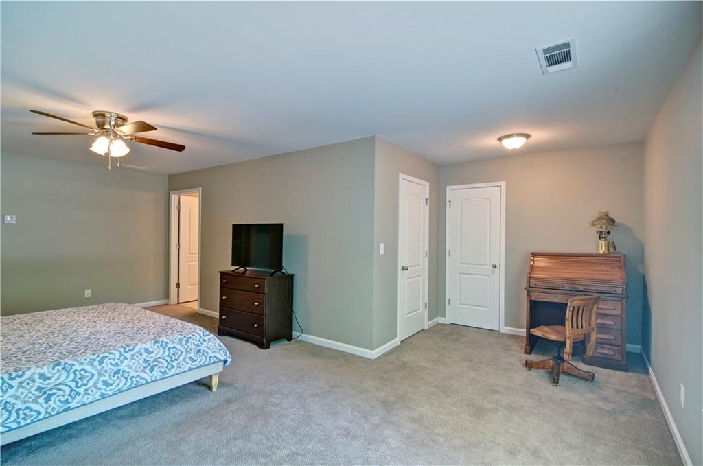 5800 Villa Rica Highway Dallas, GA 30157 - Photo 30 of 37 a bedroom with a bed and a chandelier
