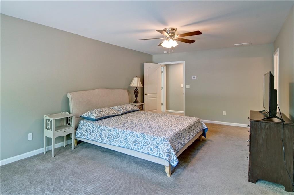 5800 Villa Rica Highway Dallas, GA 30157 - Photo 31 of 37 a bedroom with a bed and a chandelier