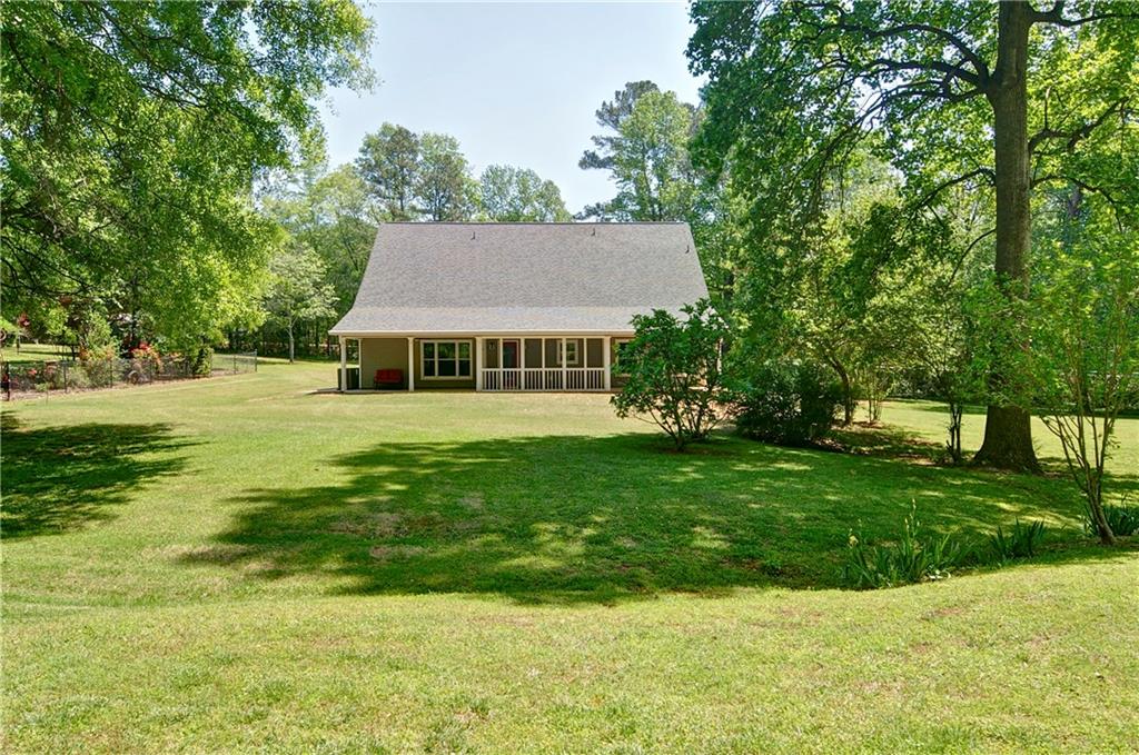 5800 Villa Rica Highway Dallas, GA 30157 - Photo 6 of 37 a view of a house with a yard potted plants and large tree