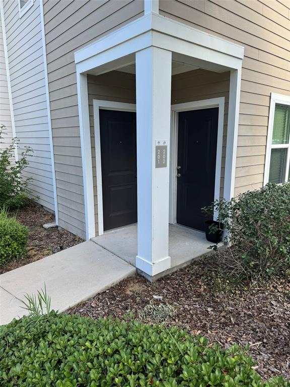 2420 Ann Rou Road, Unit 201 Tavares, FL 32778 - Photo 2 of 25 a front view of a house with a yard