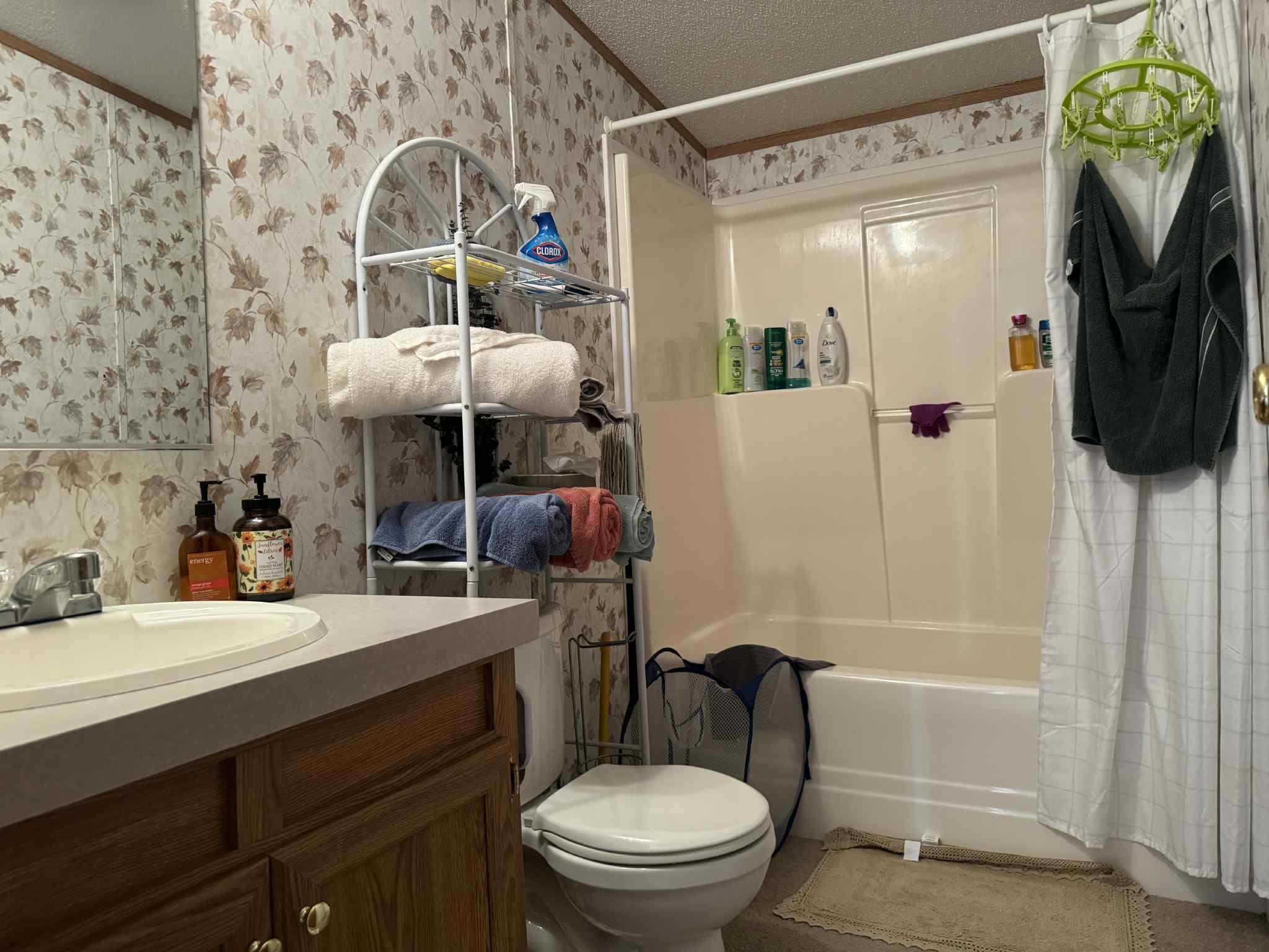 108 Todd Road Woodbourne, NY 12788 - Photo 8 of 13 Bathroom with wallpapered walls, shower / bathtub combination with curtain, vanity, and ornamental molding