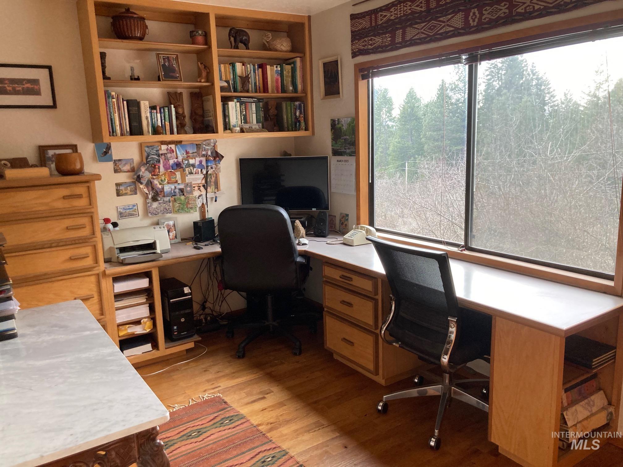 266 Falcon Ridge Road Kooskia, ID 83539 - Photo 14 of 50 Dedicated work area featuring built-in wood-finish shelving and expansive windows
