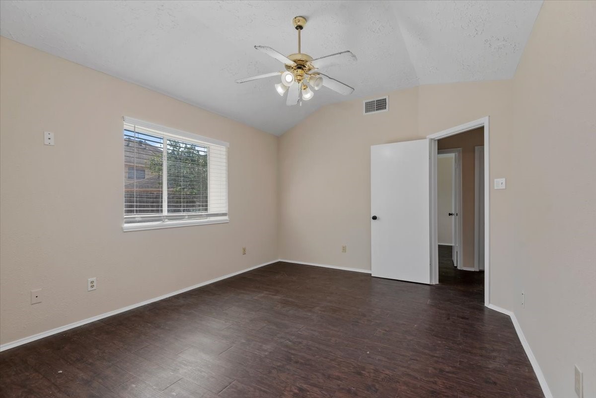 6022 Sean Court Humble, TX 77346 - Photo 13 of 18 a view of an empty room with wooden floor and a ceiling fan