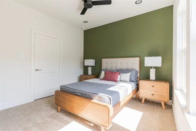 a bedroom with a bed and a mirror