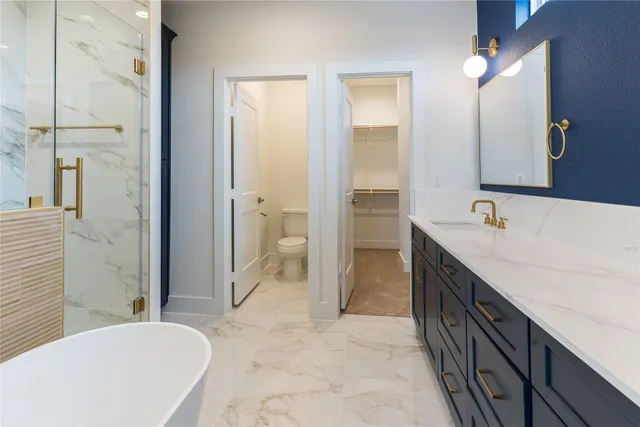 a white toilet sitting next to a white cabinet