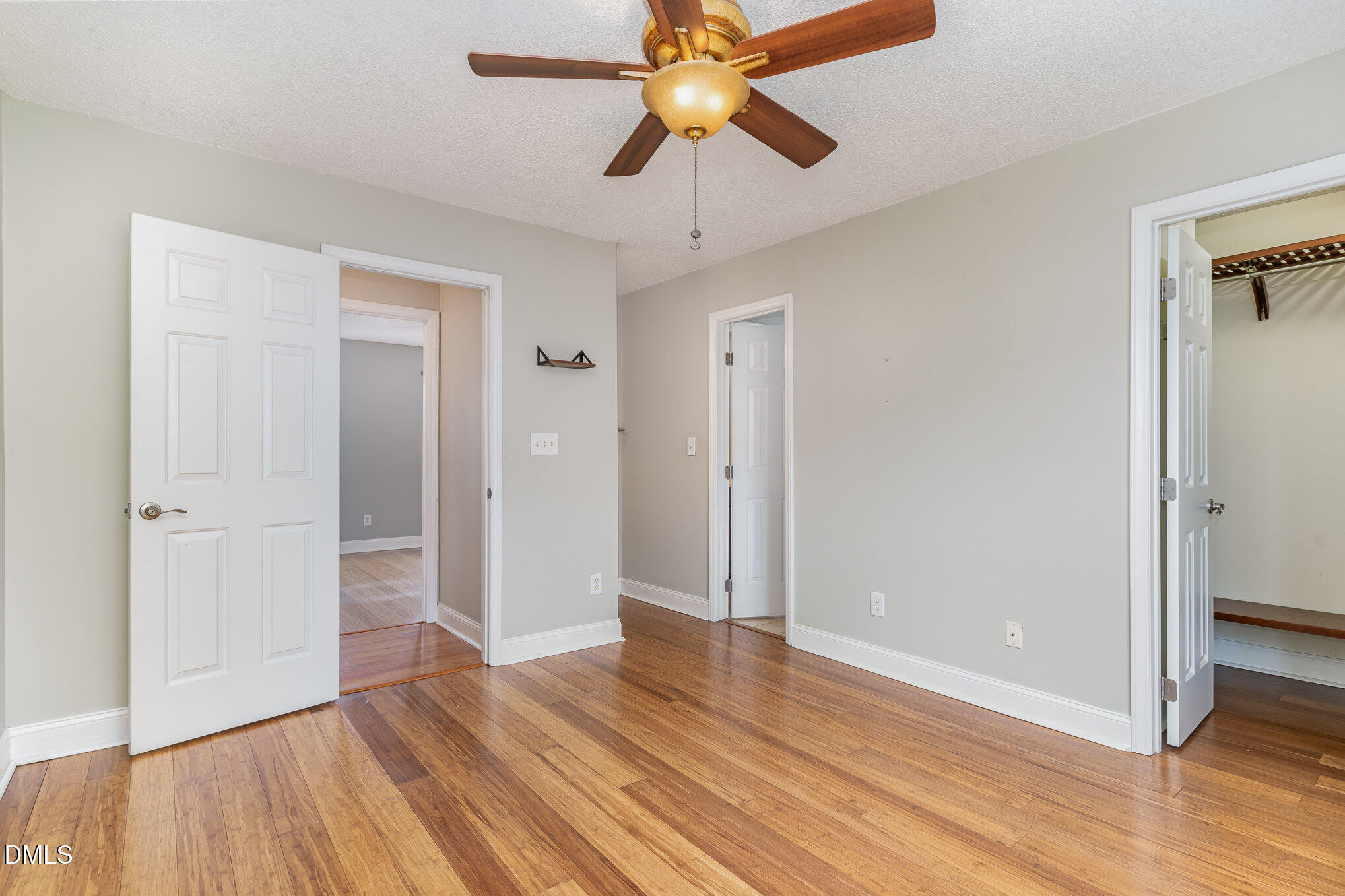 2215 Turtle Point Drive Raleigh, NC 27604 - Photo 13 of 25 a view of an empty room with window wooden floor and chandelier fan