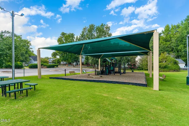 a view of a backyard with a garden and entertaining space