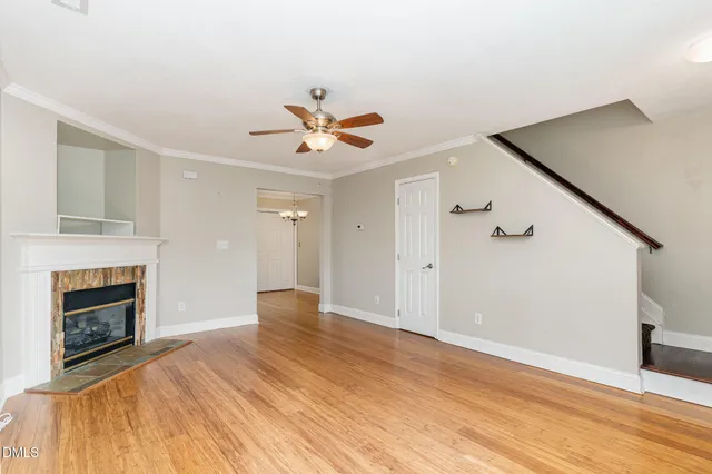 a view of a livingroom with a fireplace and wooden floor
