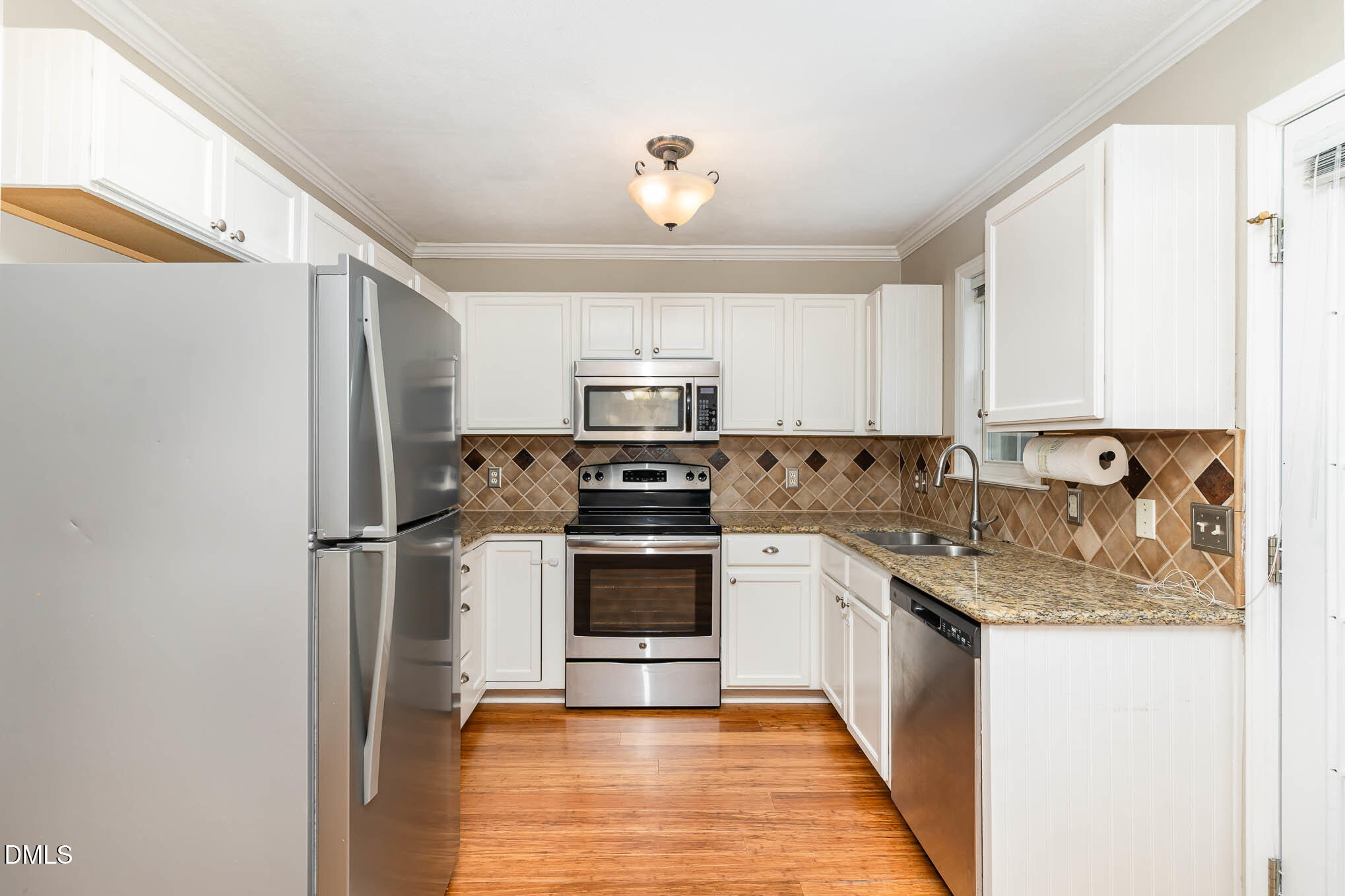 2215 Turtle Point Drive Raleigh, NC 27604 - Photo 2 of 25 a kitchen with stainless steel appliances granite countertop a refrigerator a stove and a sink